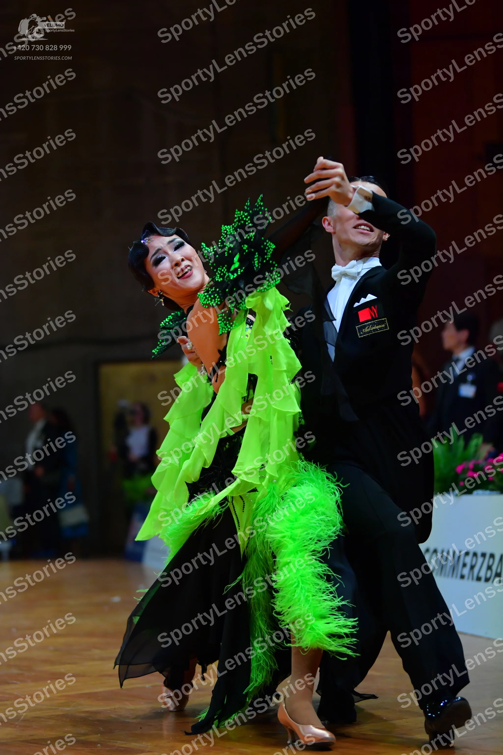 Dancesport competitor: Male dancer: black suit with a white shirt and white bow tie