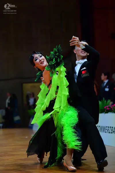 Dancesport competitor: Male dancer: black suit with a white shirt and white bow tie