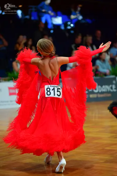 Dancesport competitor #815: Female dancer: red Latin dress with a voluminous feathery/fringed skirt and matc