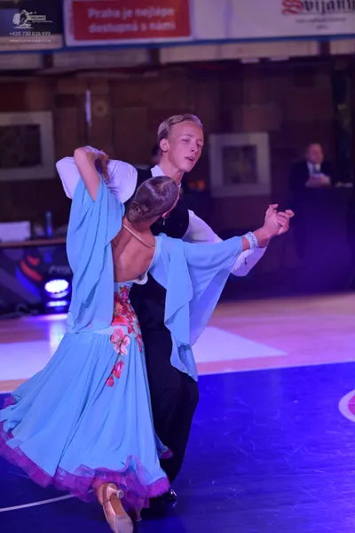 Dancesport competitor: Male dancer: white long-sleeved shirt, black waistcoat, and black trousers