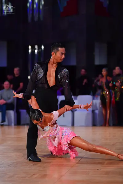 Dancesport competitor: Male dancer: black long-sleeved shirt with sequin details and black trousers