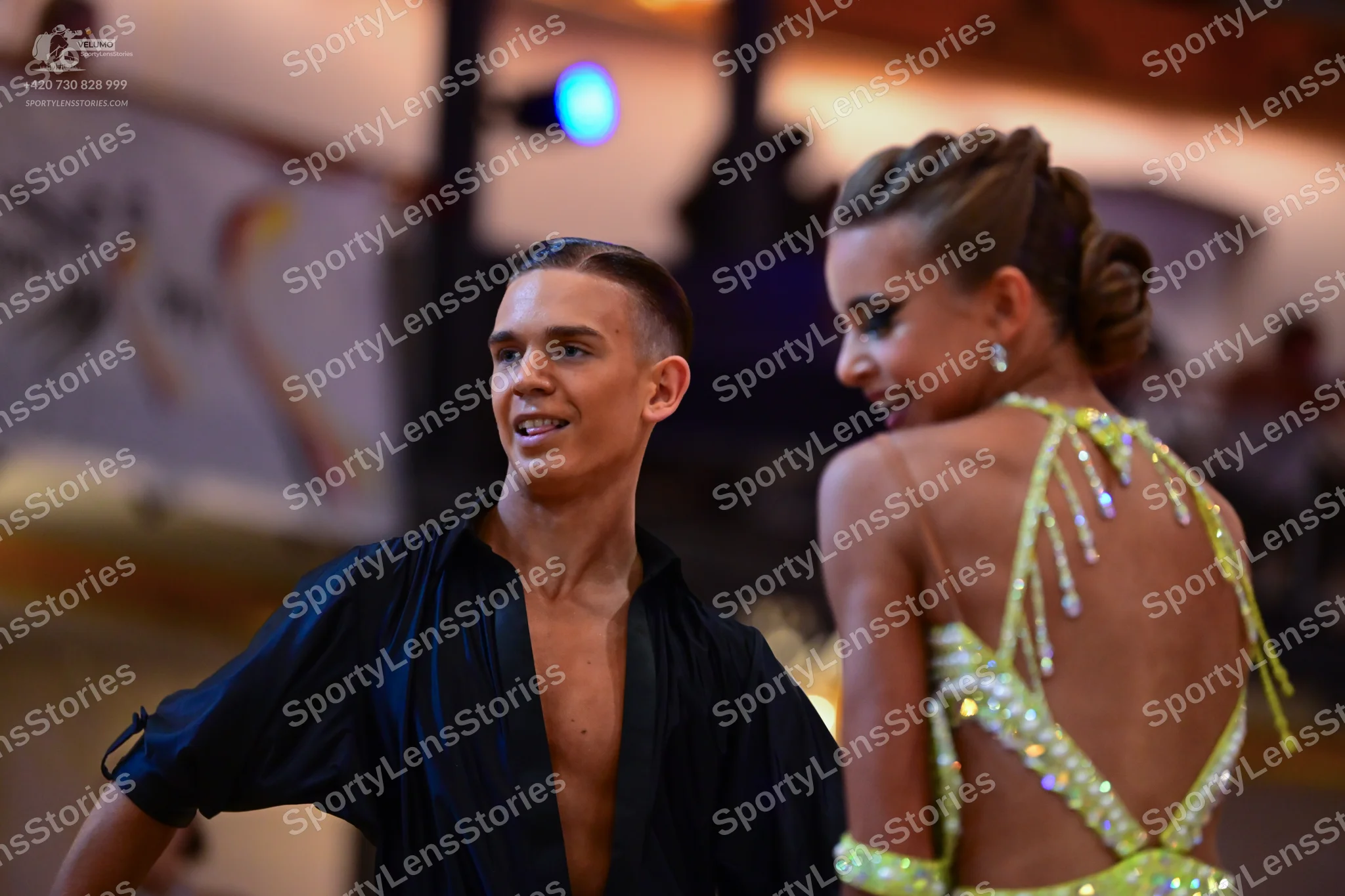 Dancesport competitor: Male dancer: black, loose-fitting, open-front Latin shirt with wide sleeves