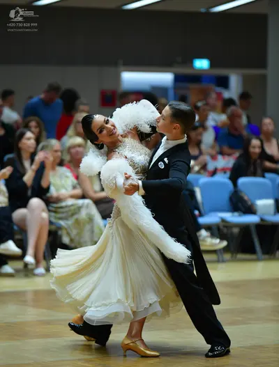 Dancesport competitor: Male dancer: black suit, white shirt, black bow tie, and black shoes