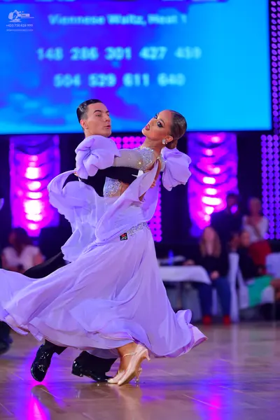 Dancesport competitor: Male dancer: black long-sleeved shirt and black trousers