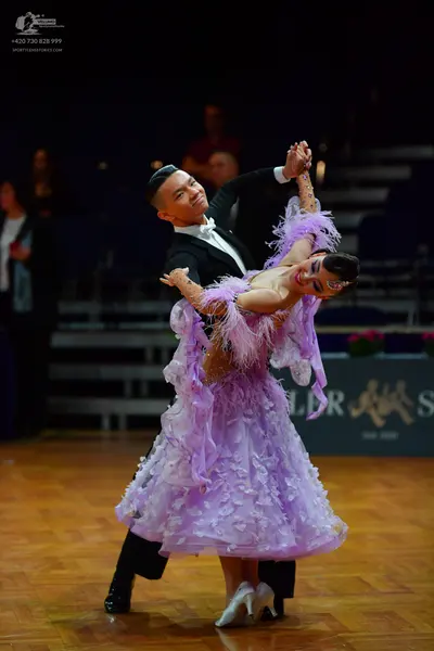 Dancesport competitor: Male dancer: black suit with a white shirt and white bow tie