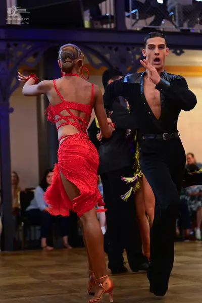 Dancesport competitor: Female dancer: red latin dress with sequins and cut-out back