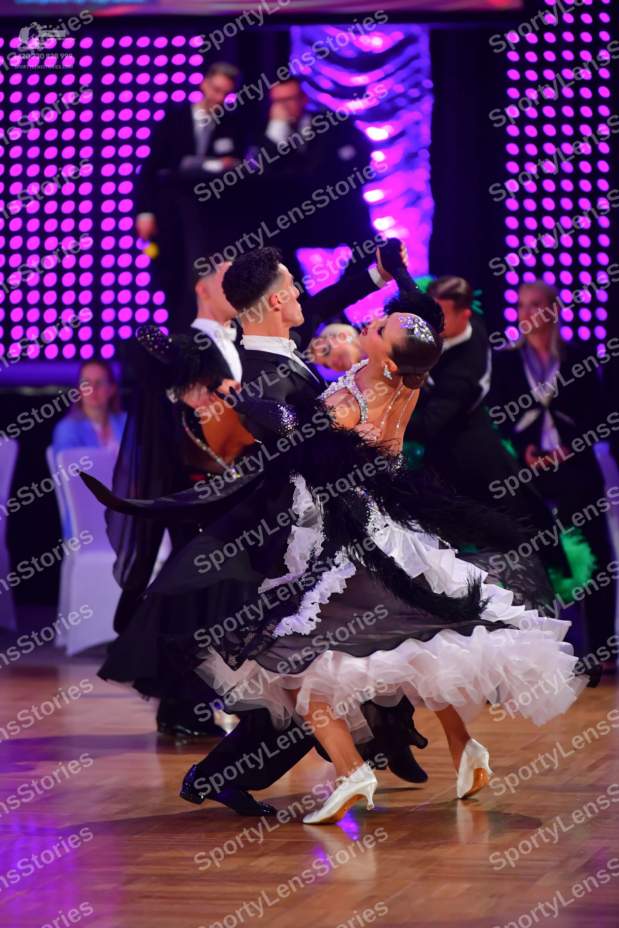 Dancesport competitor: Male dancer: black suit with a white shirt and black dance shoes