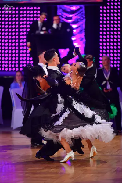 Dancesport competitor: Male dancer: black suit with a white shirt and black dance shoes