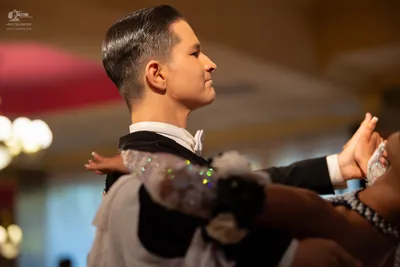 Dancesport competitor: Male dancer: black suit jacket with white/silver sequined or lace embellishments