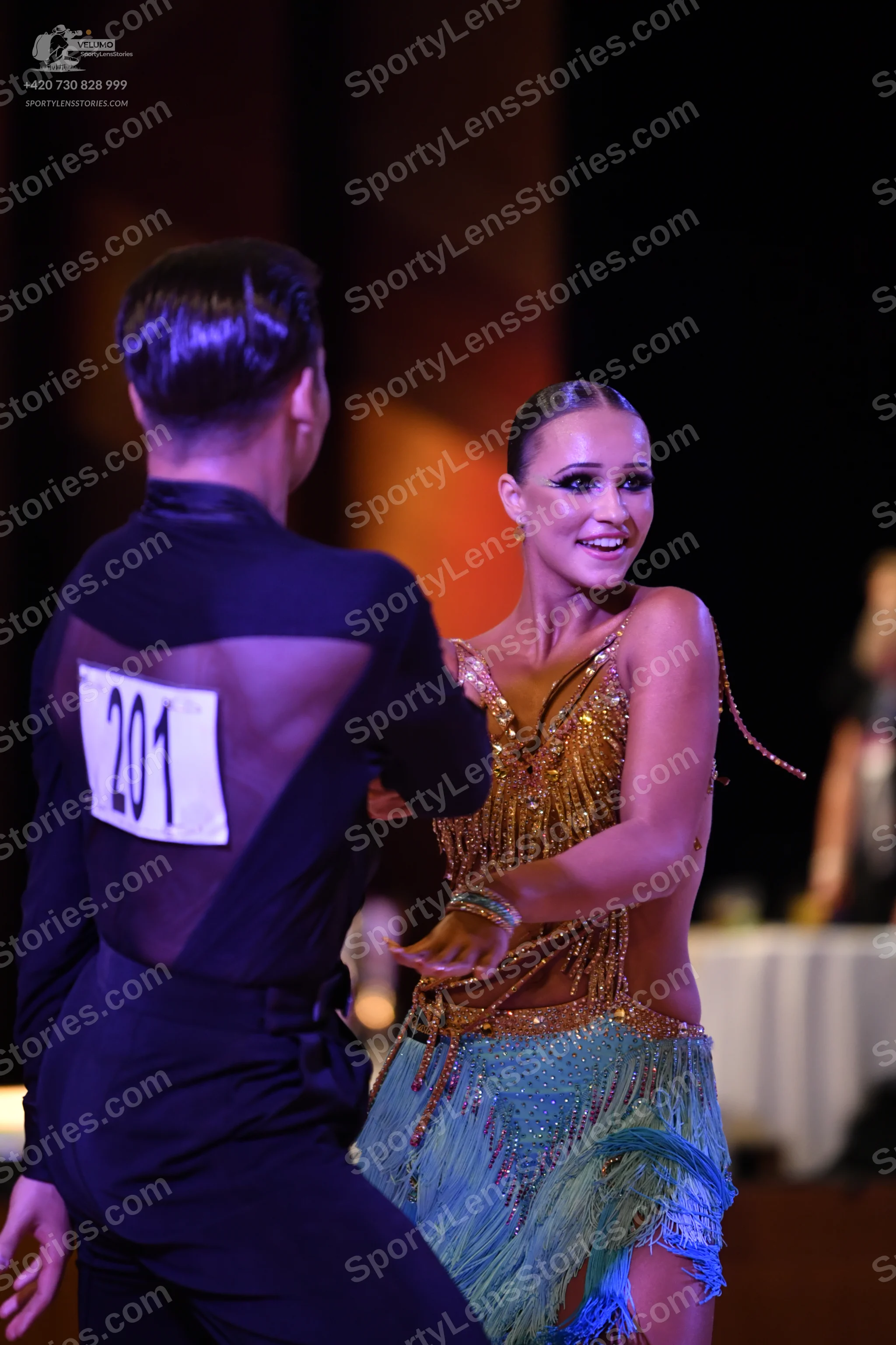 Dancesport competitor #1: Male:** Black tailsuit with a subtle, shimmering sequin pattern on the lapels