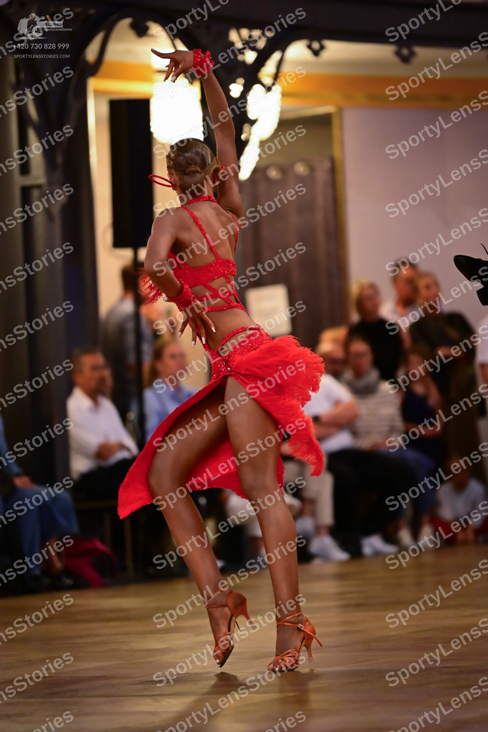 Dancesport competitor: Female dancer: red latin dress with thin straps and a backless design