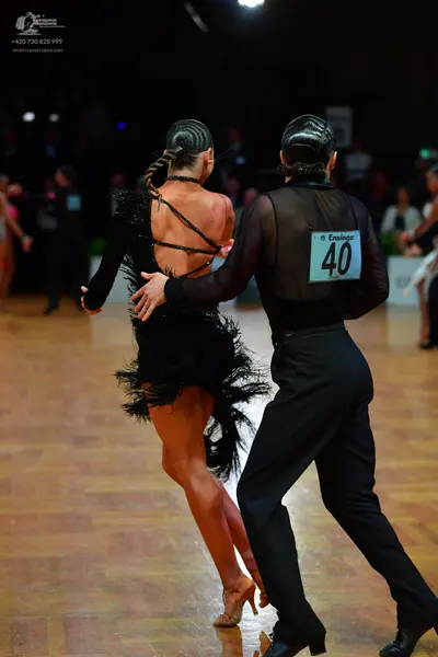 Dancesport competitor #40: Male dancer: black long-sleeved sheer top and black trousers