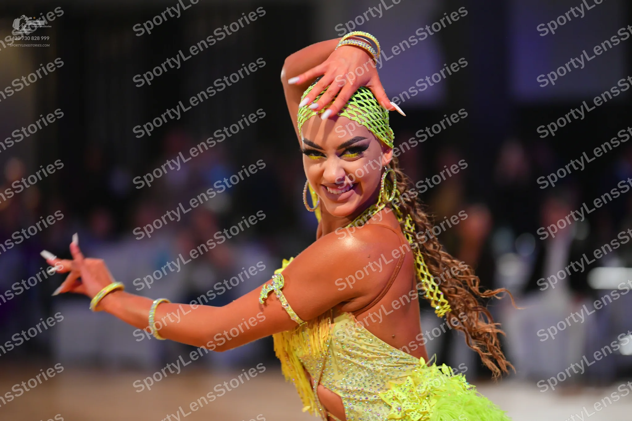 Dancesport competitor: Female dancer: lime green Latin dance dress with lace or mesh fabric and texture