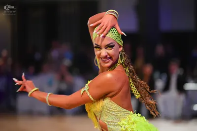 Dancesport competitor: Female dancer: lime green Latin dance dress with lace or mesh fabric and texture