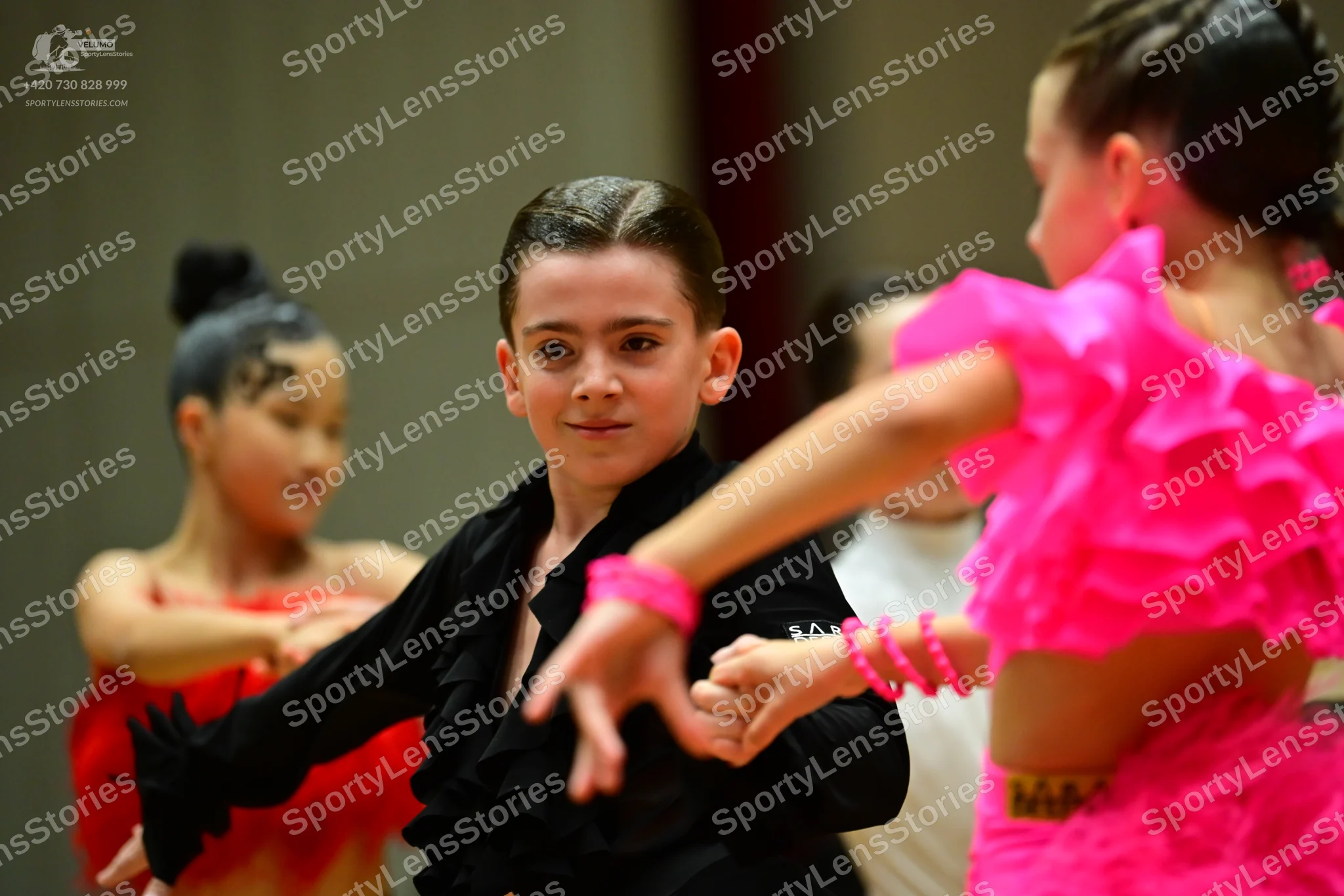 Dancesport competitor: Female dancer (left): red latin dress