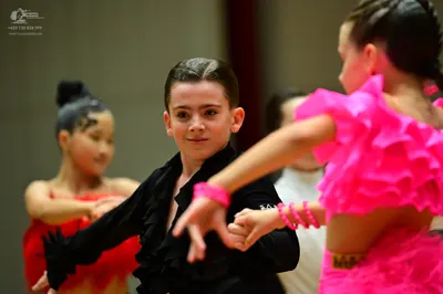 Dancesport competitor: Female dancer (left): red latin dress