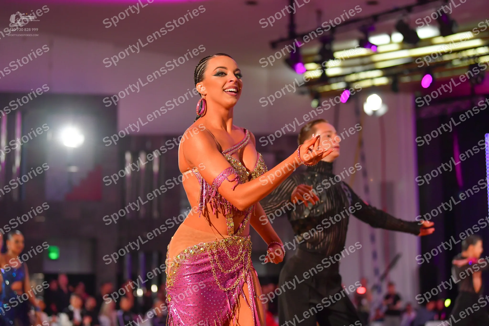 Dancesport competitor: Female dancer: Magenta Latin dance dress with heavy sequin and bead embellishmen