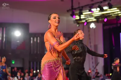 Dancesport competitor: Female dancer: Magenta Latin dance dress with heavy sequin and bead embellishmen