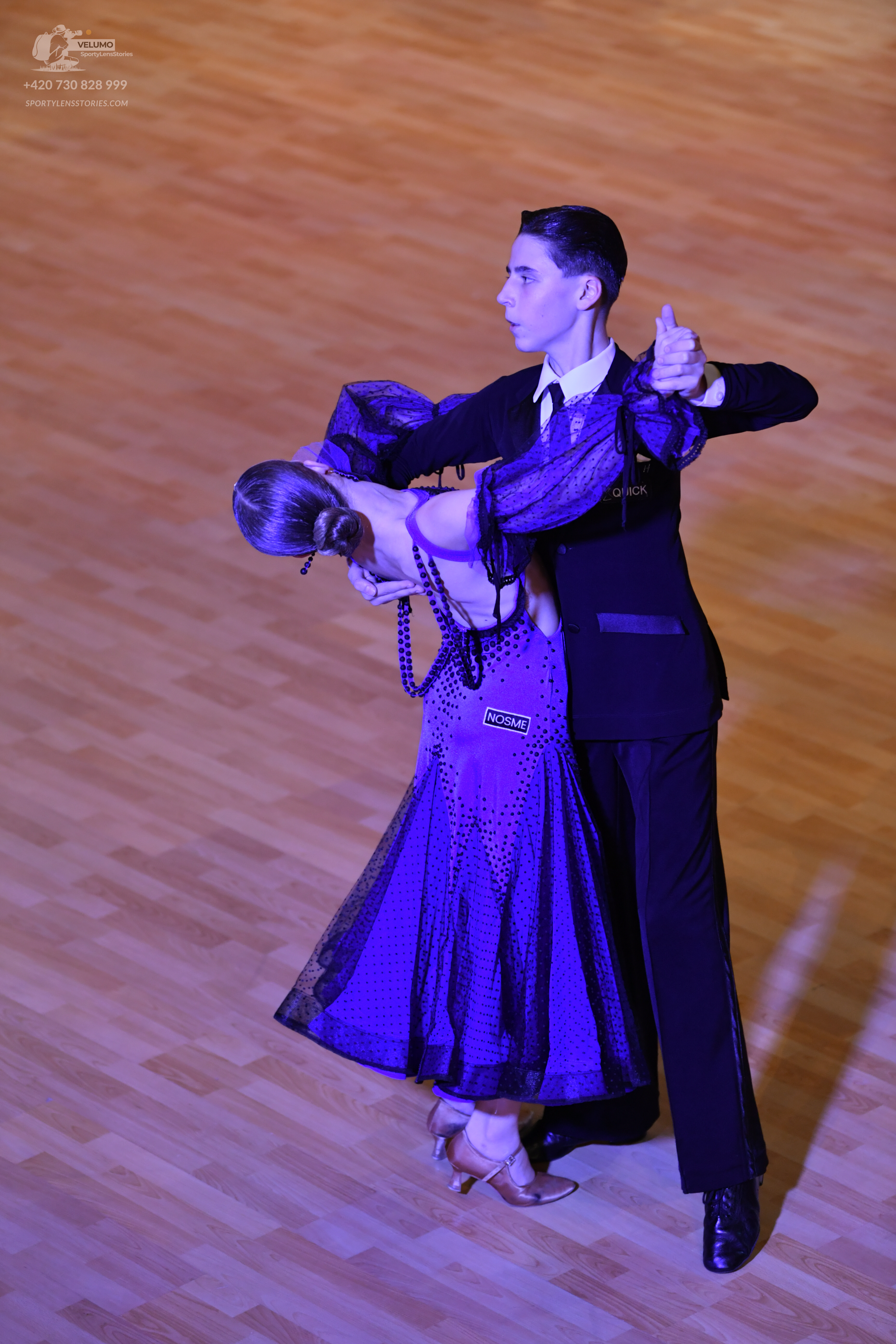 Dancesport competitor: Male dancer: black suit, white shirt, and black tie