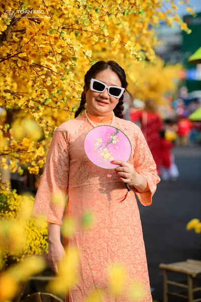 Dancesport competitor: Female dancer: peach long-sleeved dress with a subtle floral pattern and a high 