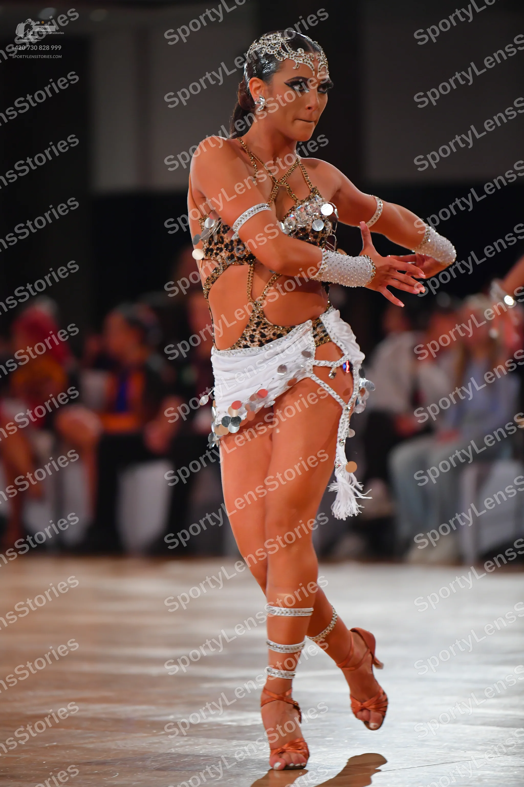 Dancesport competitor: Female dancer: leopard print latin costume with silver mirror/sequin embellishme