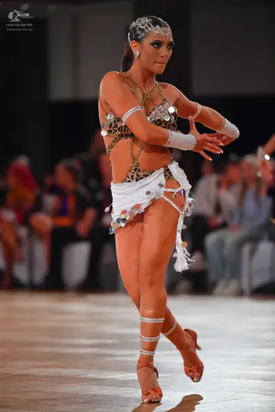Dancesport competitor: Female dancer: leopard print latin costume with silver mirror/sequin embellishme