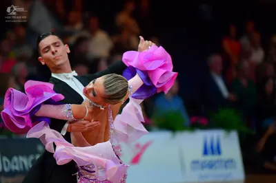 Dancesport competitor: Male dancer: black suit with a white shirt and white bowtie