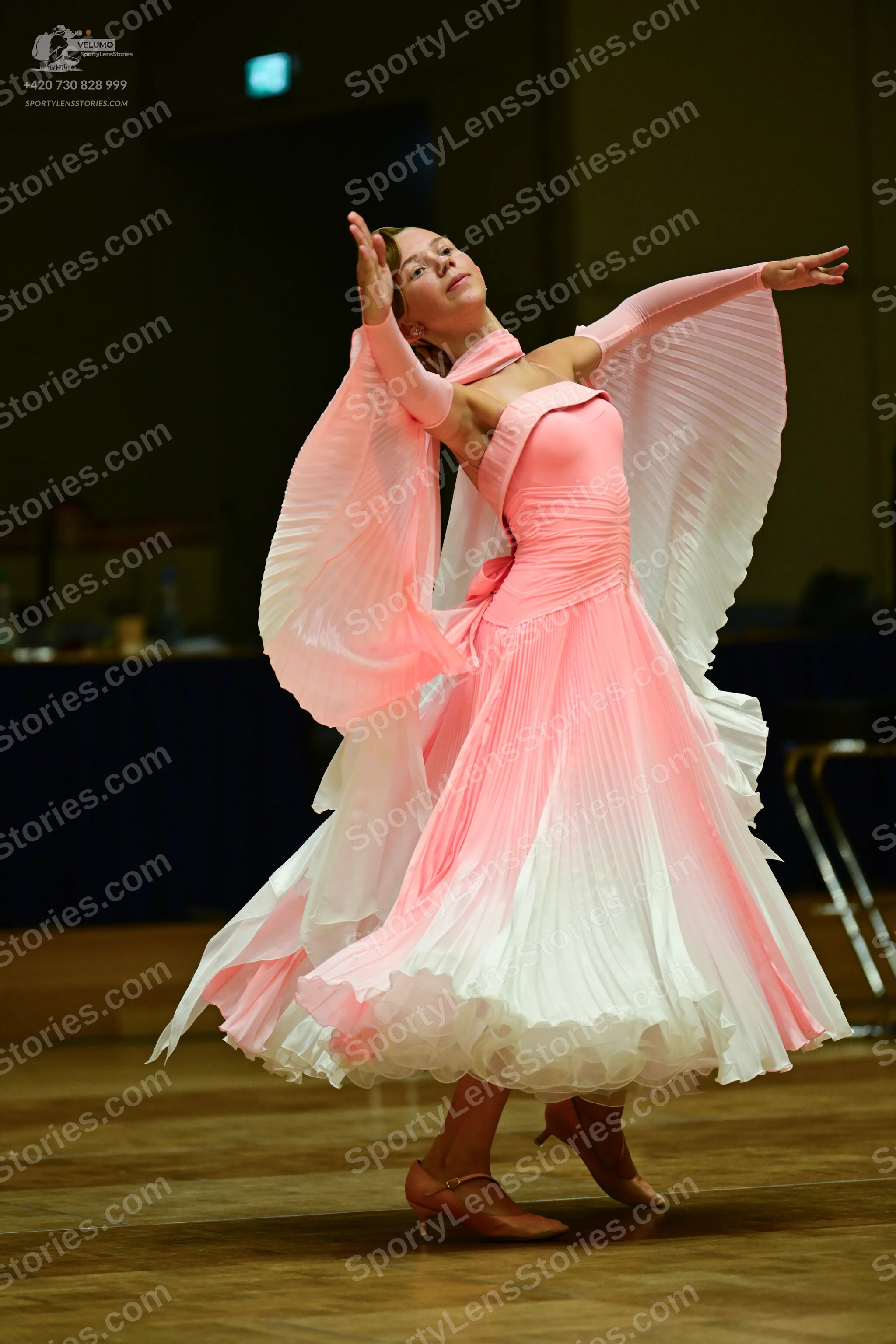Dancesport competitor: Female**

*   **Color:** Pale Pink (primarily) with white accents
*   **Fabric:*