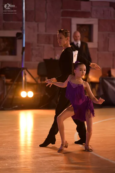 Dancesport competitor: Male dancer: black long-sleeved shirt and black trousers