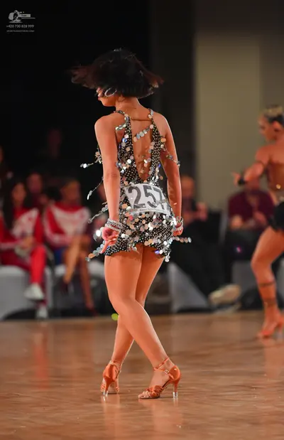 Dancesport competitor #257: Female dancer (foreground): black latin dress heavily embellished with large sil