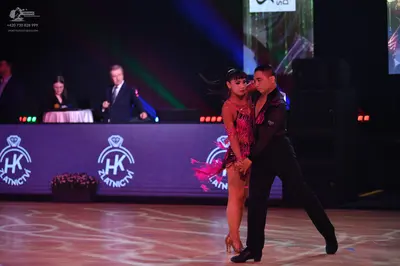 Dancesport competitor: Male dancer: black long-sleeved top and black trousers