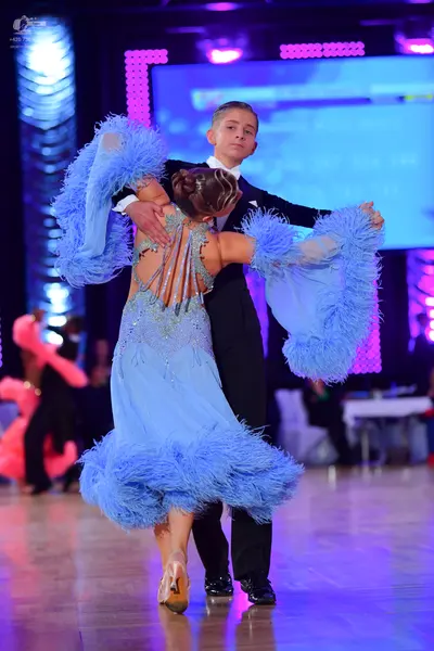 Dancesport competitor: Male dancer: black suit with a white shirt and black trousers