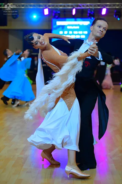 Dancesport competitor: Female dancer: white ballroom dress with a nude-colored, rhinestone-embellished 