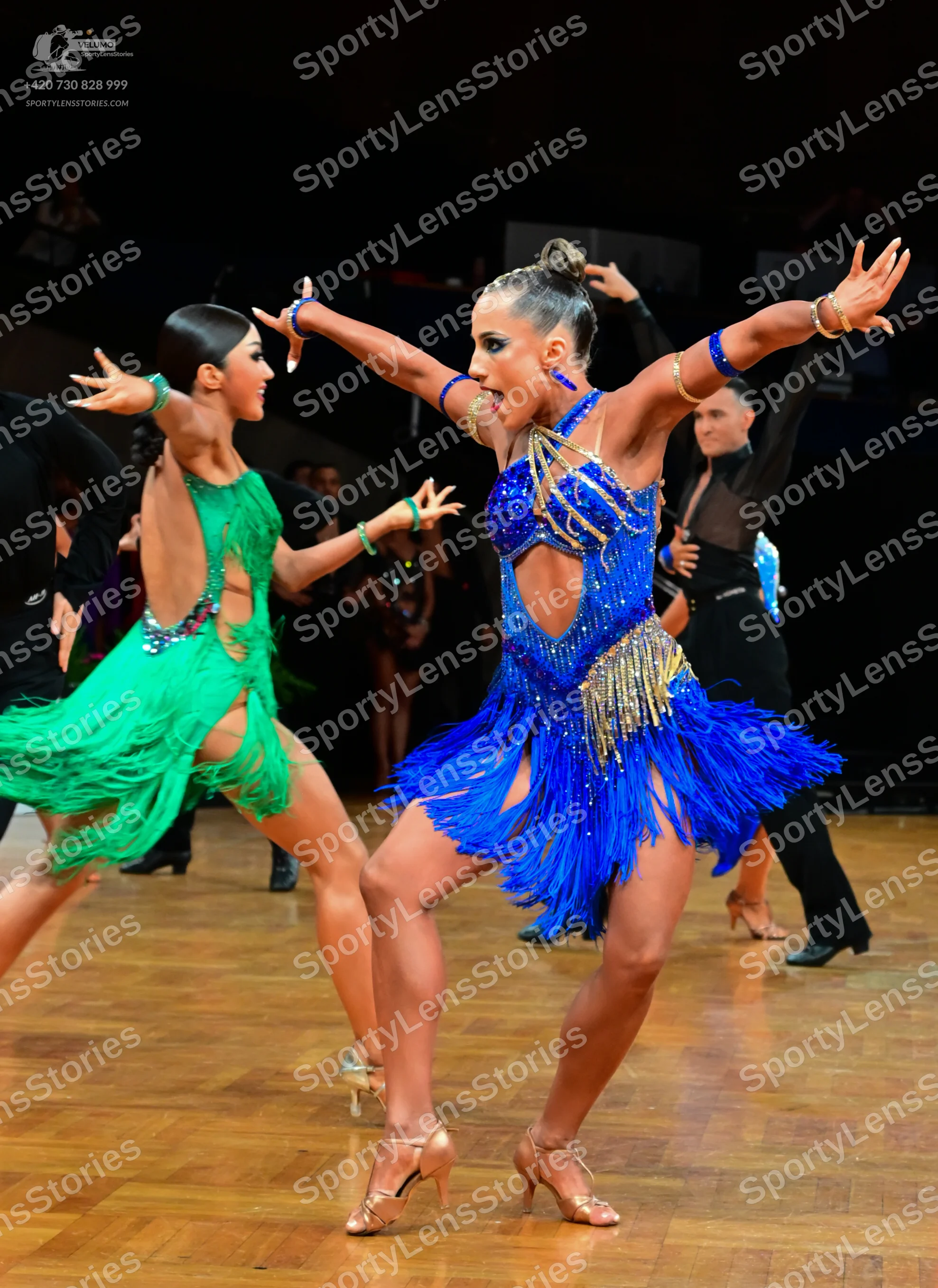 Dancesport competitor: Female dancer 1: green Latin dress with fringe and sequins