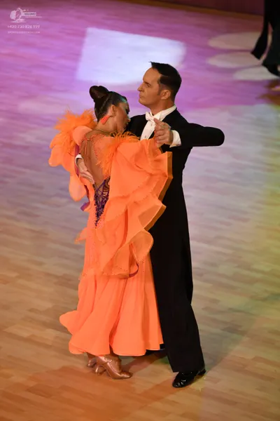 Dancesport competitor: ** Black suit with a shimmering sequin lapel and a black satin shirt