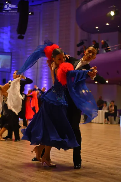 Dancesport competitor: Male dancer: black suit with a white shirt and black bow tie
