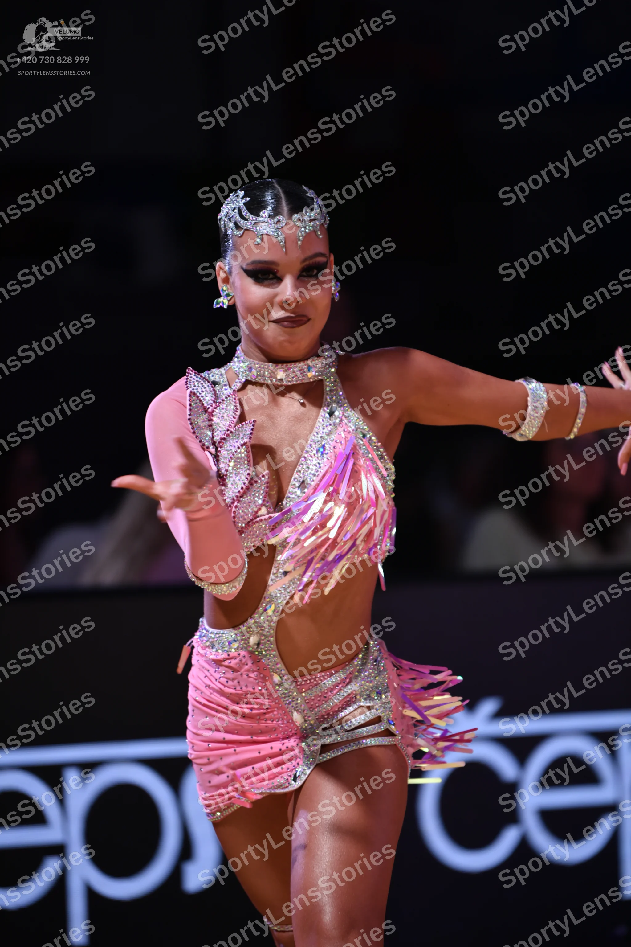Dancesport competitor: Female dancer: pink latin dance costume with silver sequin patterns, featuring f