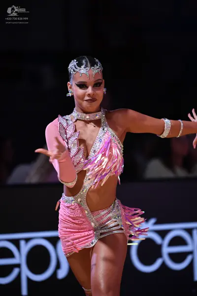 Dancesport competitor: Female dancer: pink latin dance costume with silver sequin patterns, featuring f