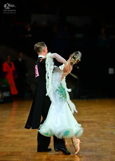 Dancesport competitor: Male dancer: black tailcoat, white shirt, black bow tie, and black trousers