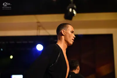 Dancesport competitor: ** Black tailsuit
*   **Fabric:** Primarily black satin, with sequin detailing o