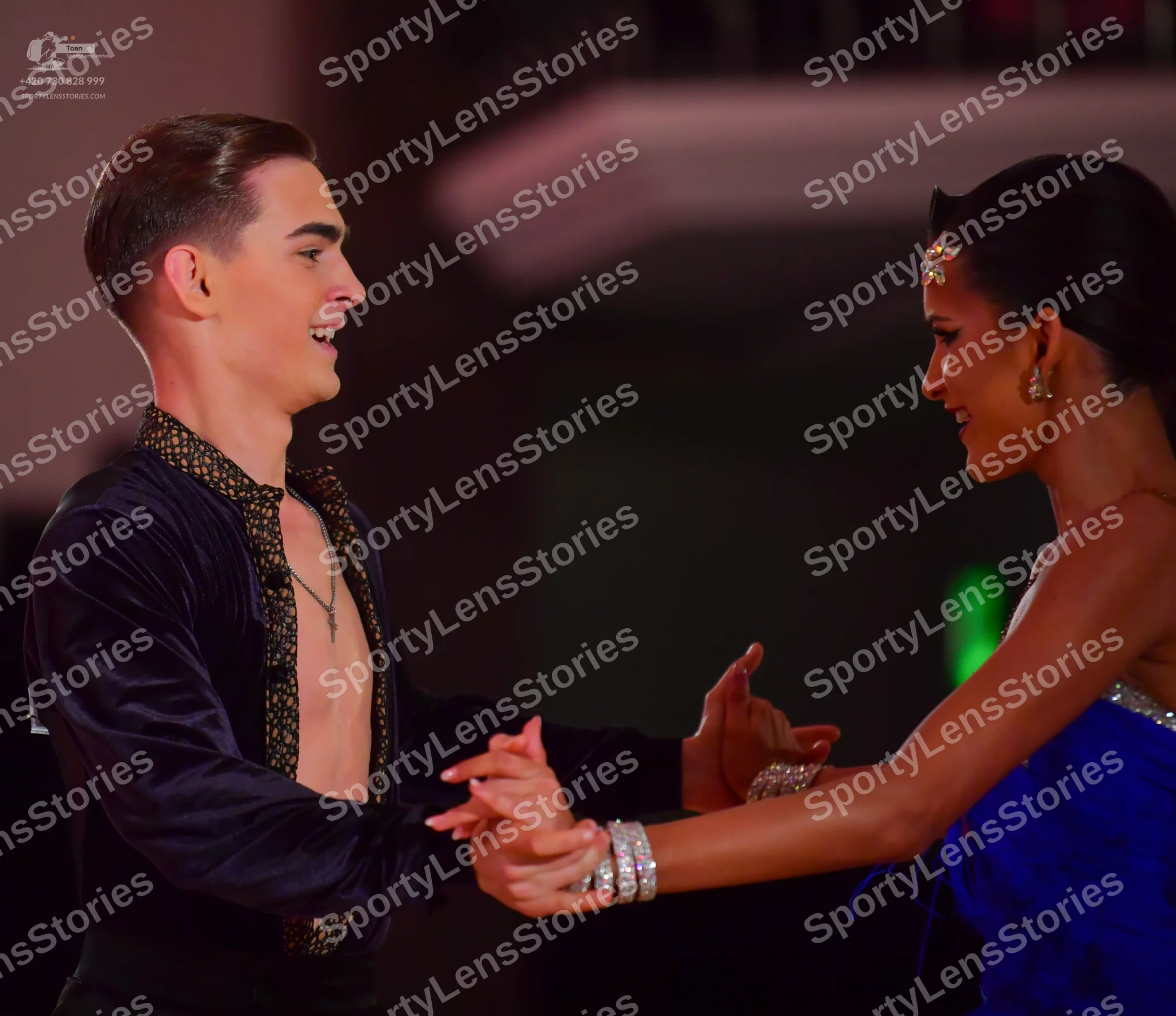 Dancesport competitor: Male dancer: black long-sleeved shirt with a deep V-neck and gold patterned trim