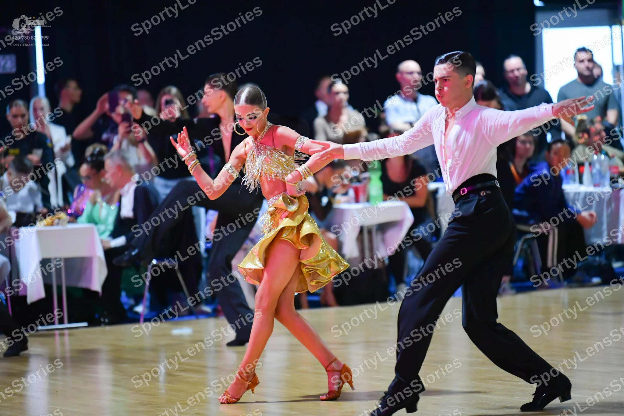 Dancesport competitor: Male dancer: long-sleeved white shirt, black trousers, and black dance shoes