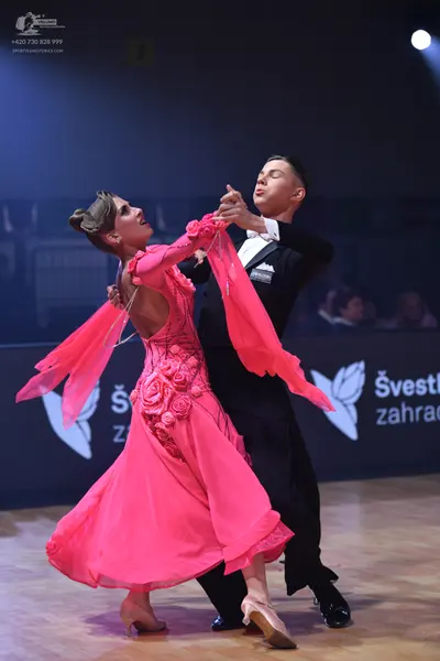 Dancesport competitor: Male dancer: black suit with a white shirt and white bowtie