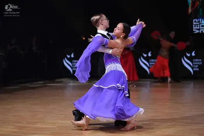 Dancesport competitor: Male dancer: white shirt with black waistcoat and black trousers
