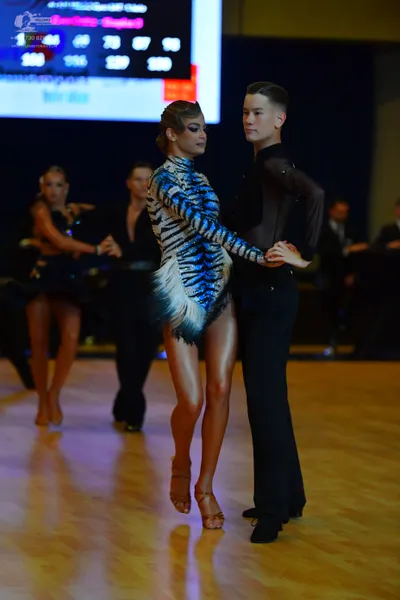 Dancesport competitor: Main female dancer: blue and black tiger-print latin dress with fringe