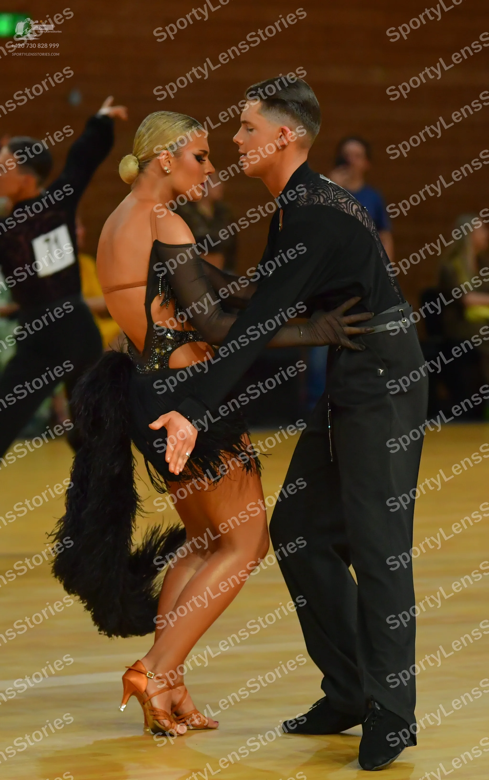 Dancesport competitor: ** Red Latin dress
*   **Color:** Primarily red
*   **Fabric:** Satin (appears t