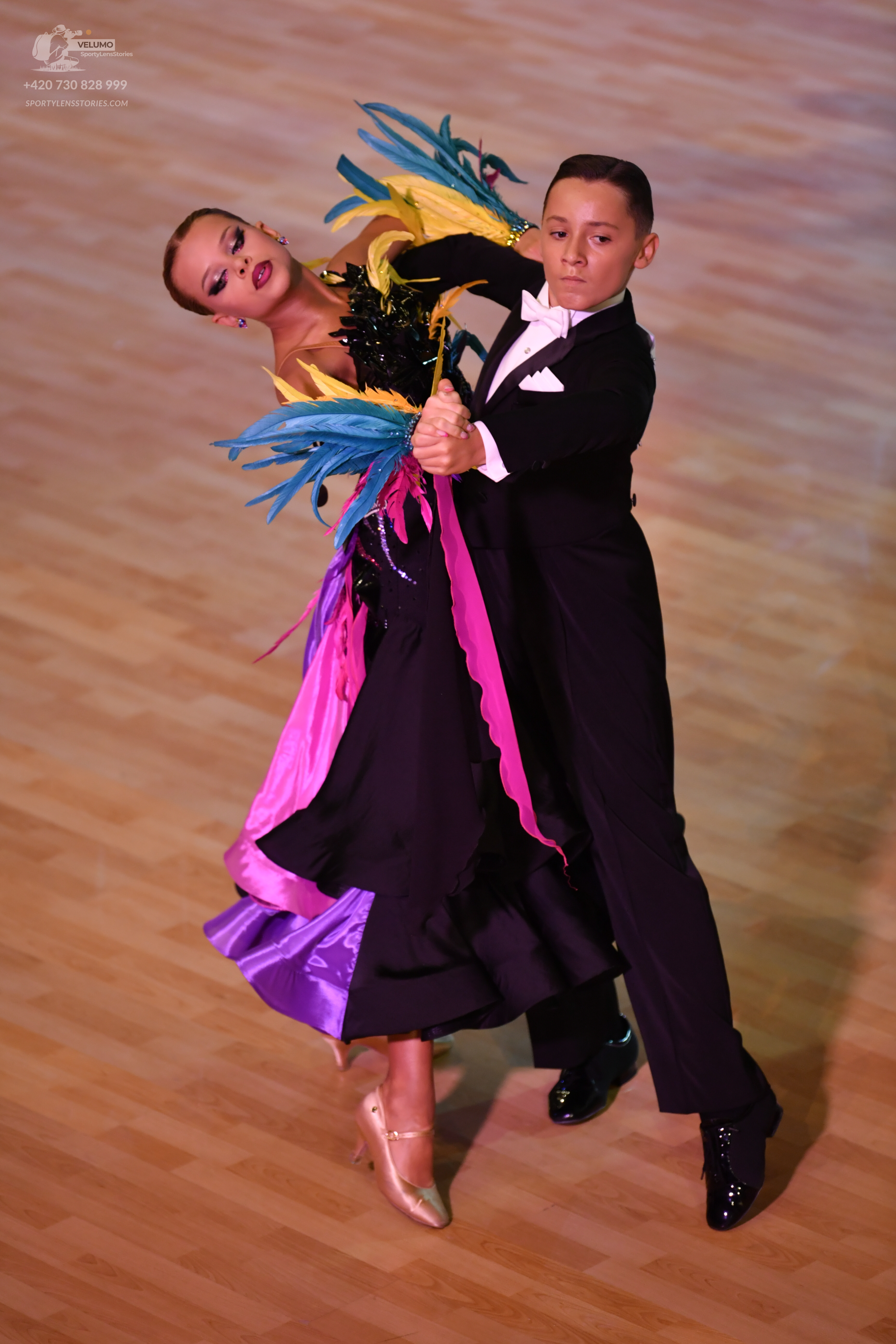 Dancesport competitor: Male dancer: black suit with a white shirt and white bow tie
