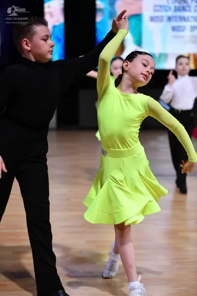 Dancesport competitor: Male dancer: black long-sleeved shirt and black trousers