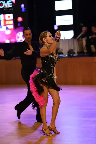 Dancesport competitor: Male dancer: black long-sleeved shirt and black trousers