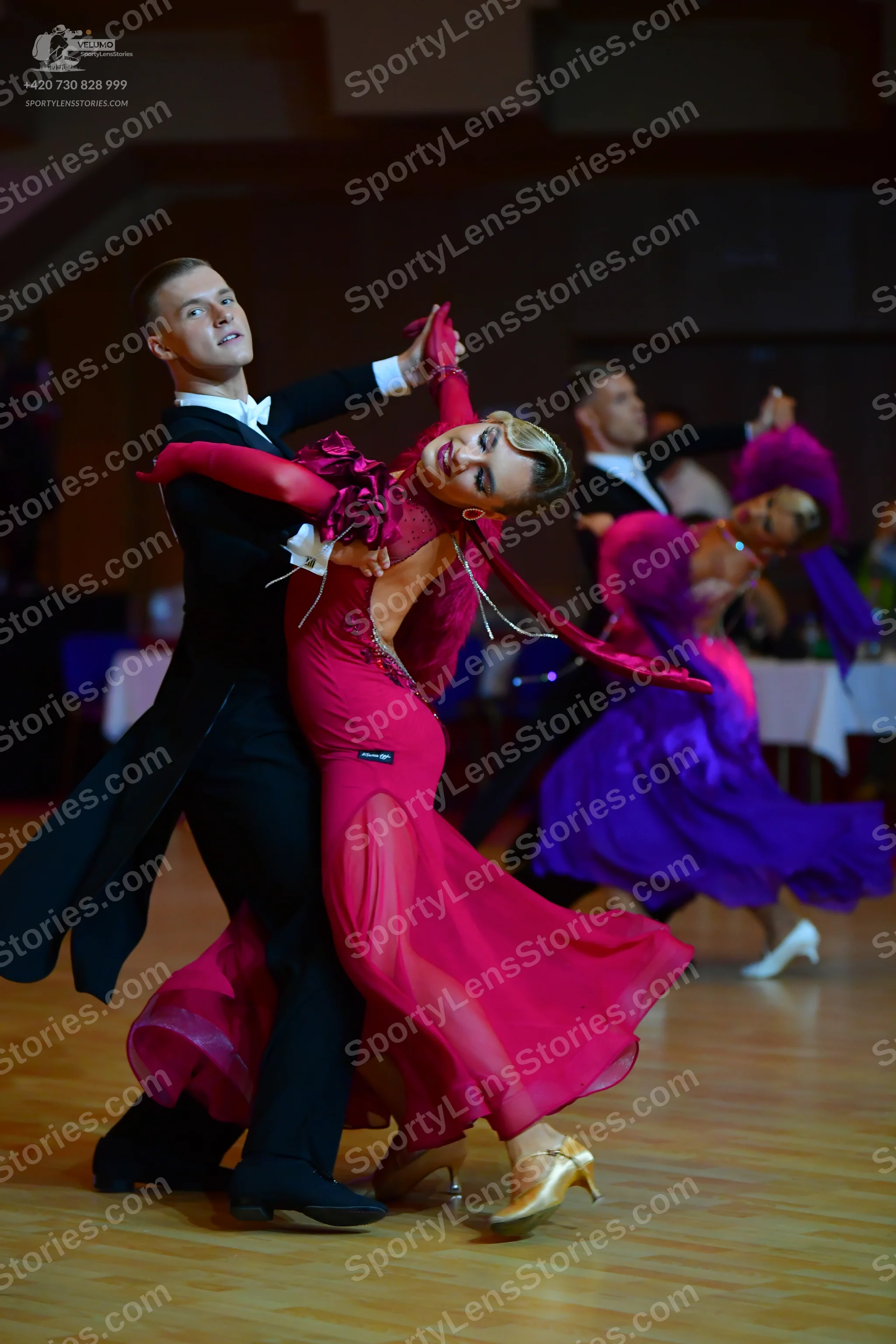 Dancesport competitor: Male dancer 1: black ballroom tailcoat, white shirt, white bow tie, and black tr